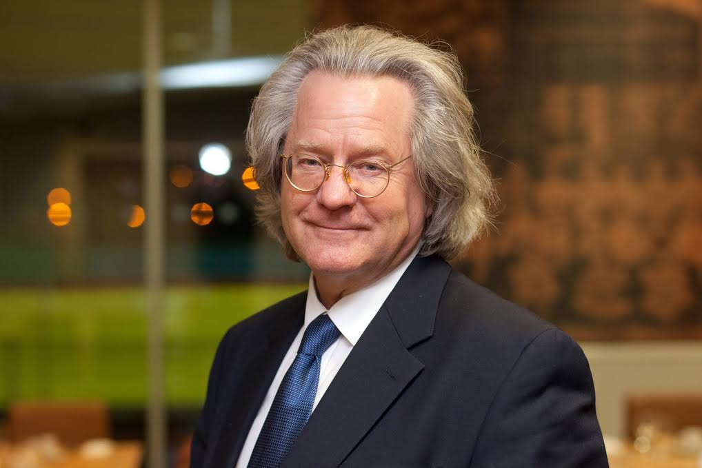 A photo of AC Grayling in a suit, smiling.