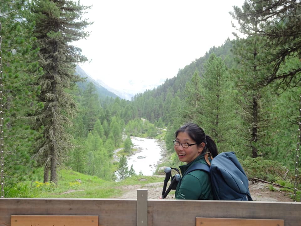 woman on wooden seat in the hills 