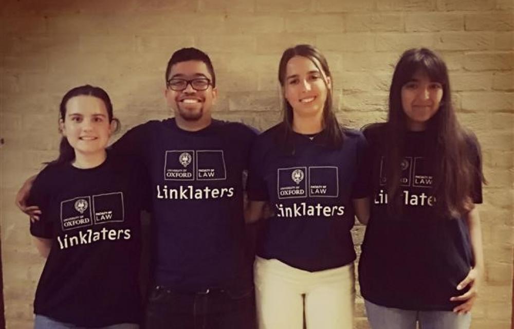 Four students wearing Linklaters T-shirts