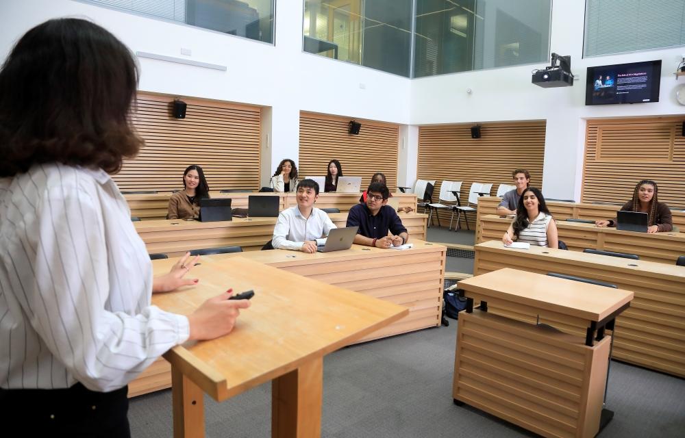 Students listening to a lecture in The Cube facility within the St Cross Building