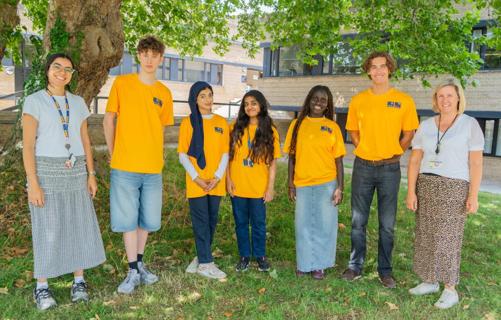 Faculty of Law student ambassadors and staff standing on the grass outside the St Cross Building on an Open Day