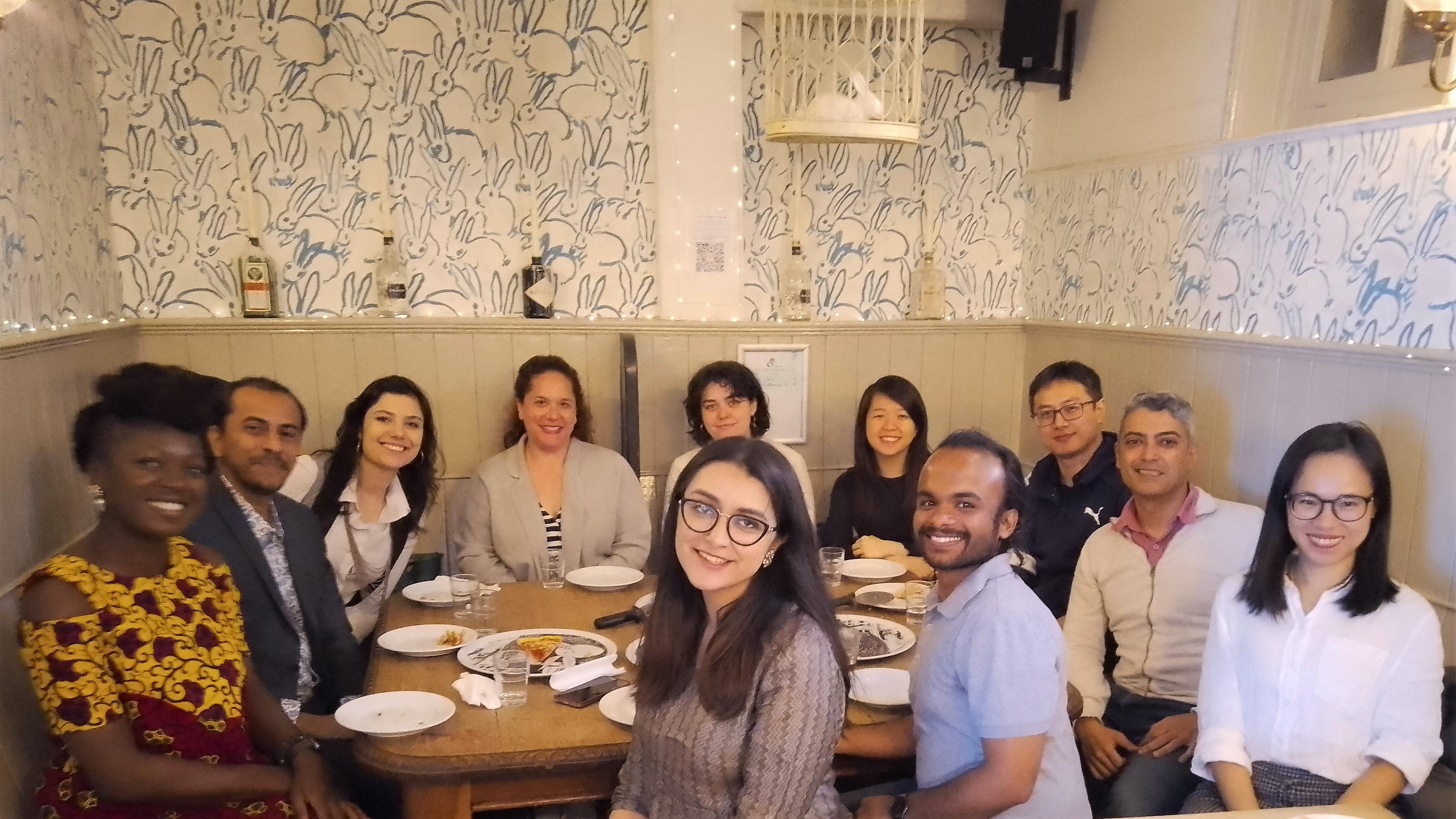 OIPRC graduate student members and visiting researchers discussing food for thought over pizzas