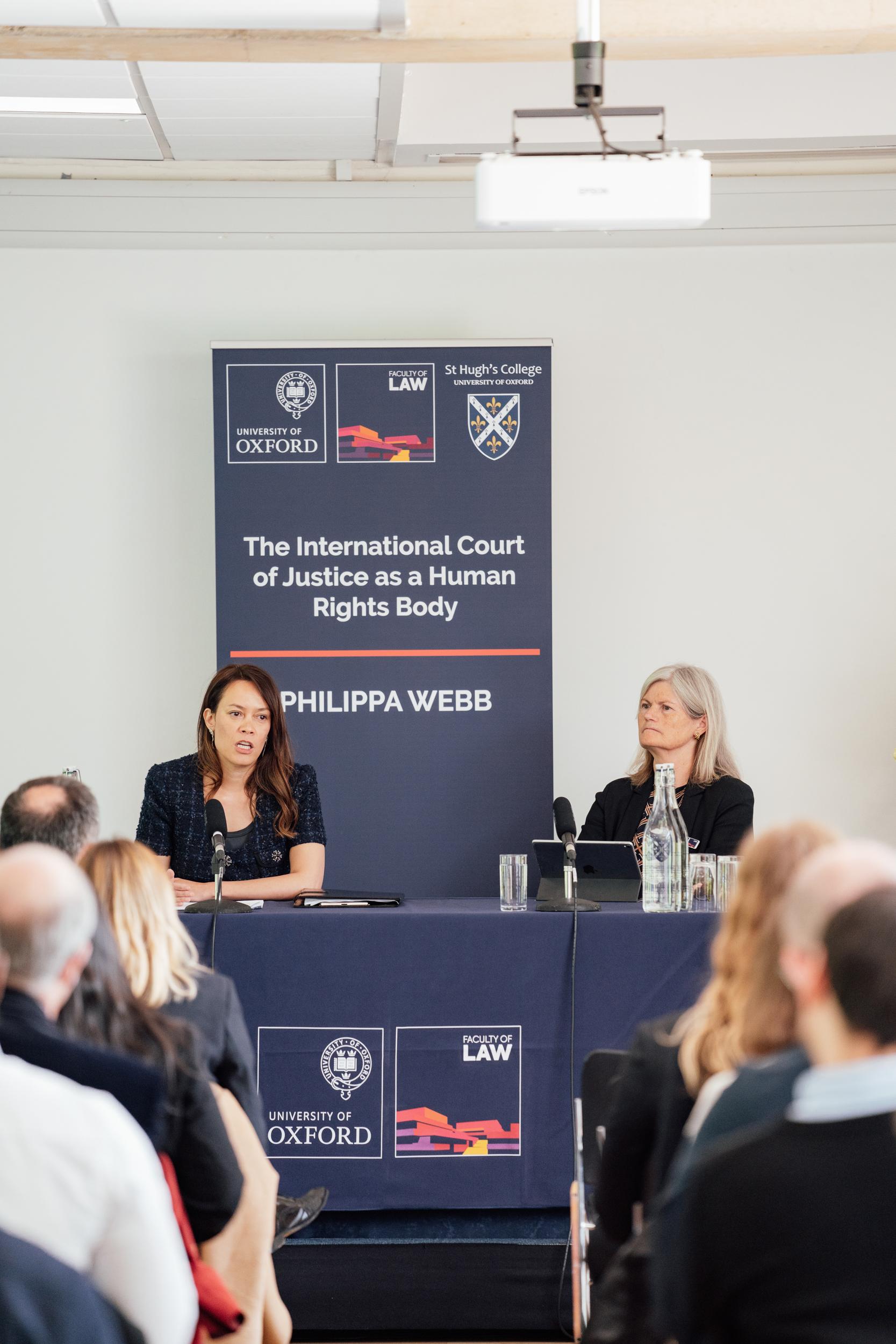 Philippa Webb and Kate O'Regan seated in front of an audience