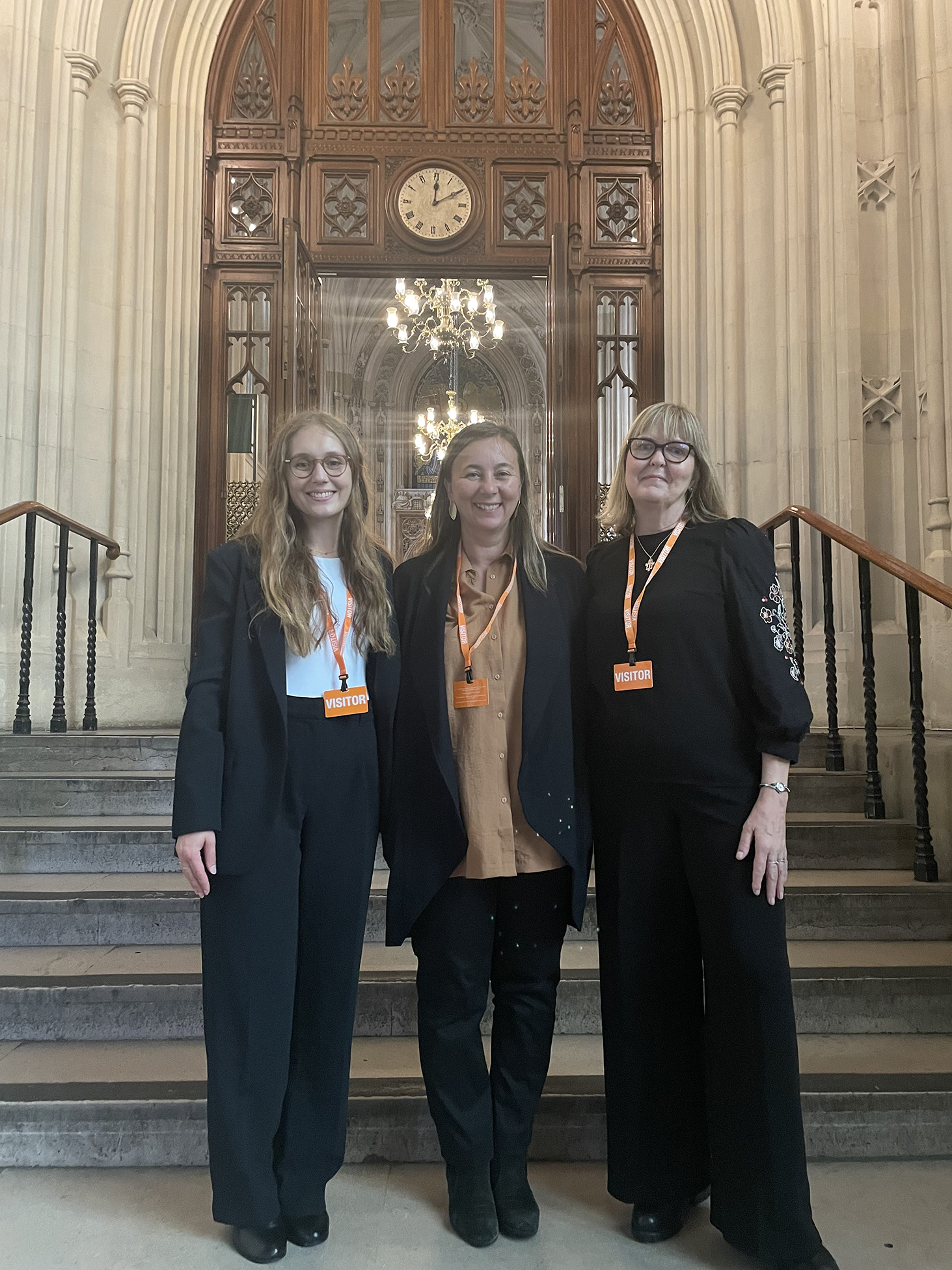 Victoria Adelmant, Alice Donald  and Başak Çali standing in a doorway at the Houses of Parliament