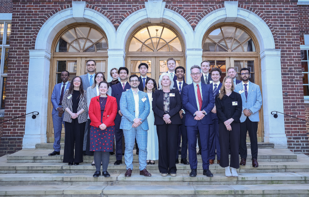 Students and staff from the Faculty of Law standing on steps outside Gray's Inn in London