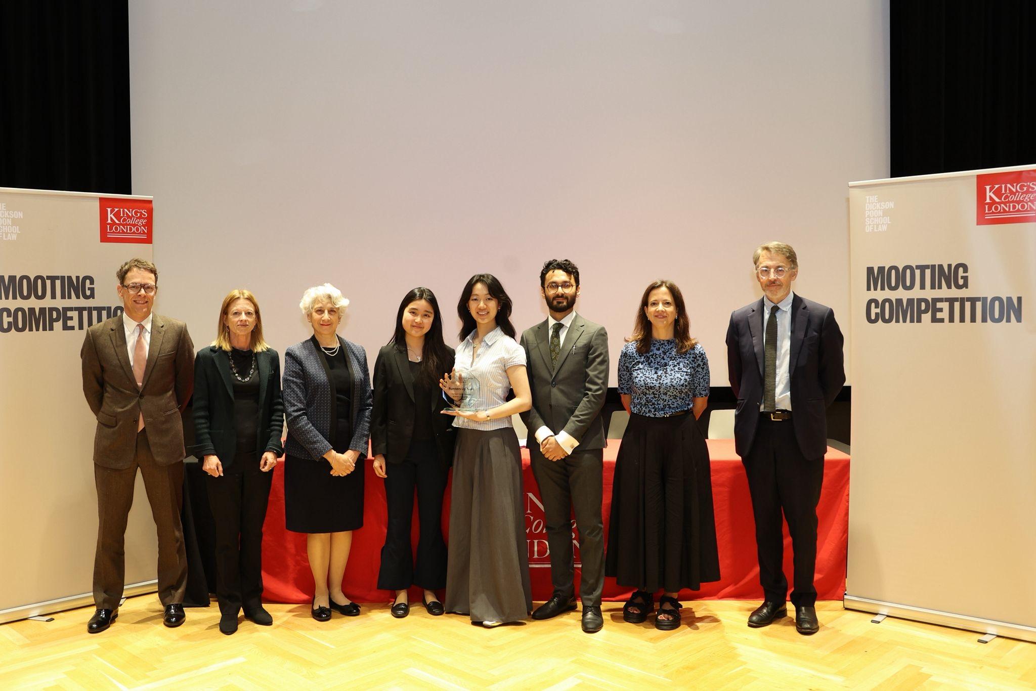 The Oxford team with the judges for the final round, left to right: Daniel Beard KC (Barrister, Monckton Chambers), Prof Alison Jones (Vice Dean and Professor of Law, King's College London), The Right Hon Lady Rose of Colmworth, Sum Lau, Yvette Young, Syed Adil, Lucilia Falsarella Pereira (Senior Director, Enforcement, UK Competition and Markets Authority), and Stephen Wisking Partner (Competition, Regulation and Trade, Herbert Smith Freehills Kramer).