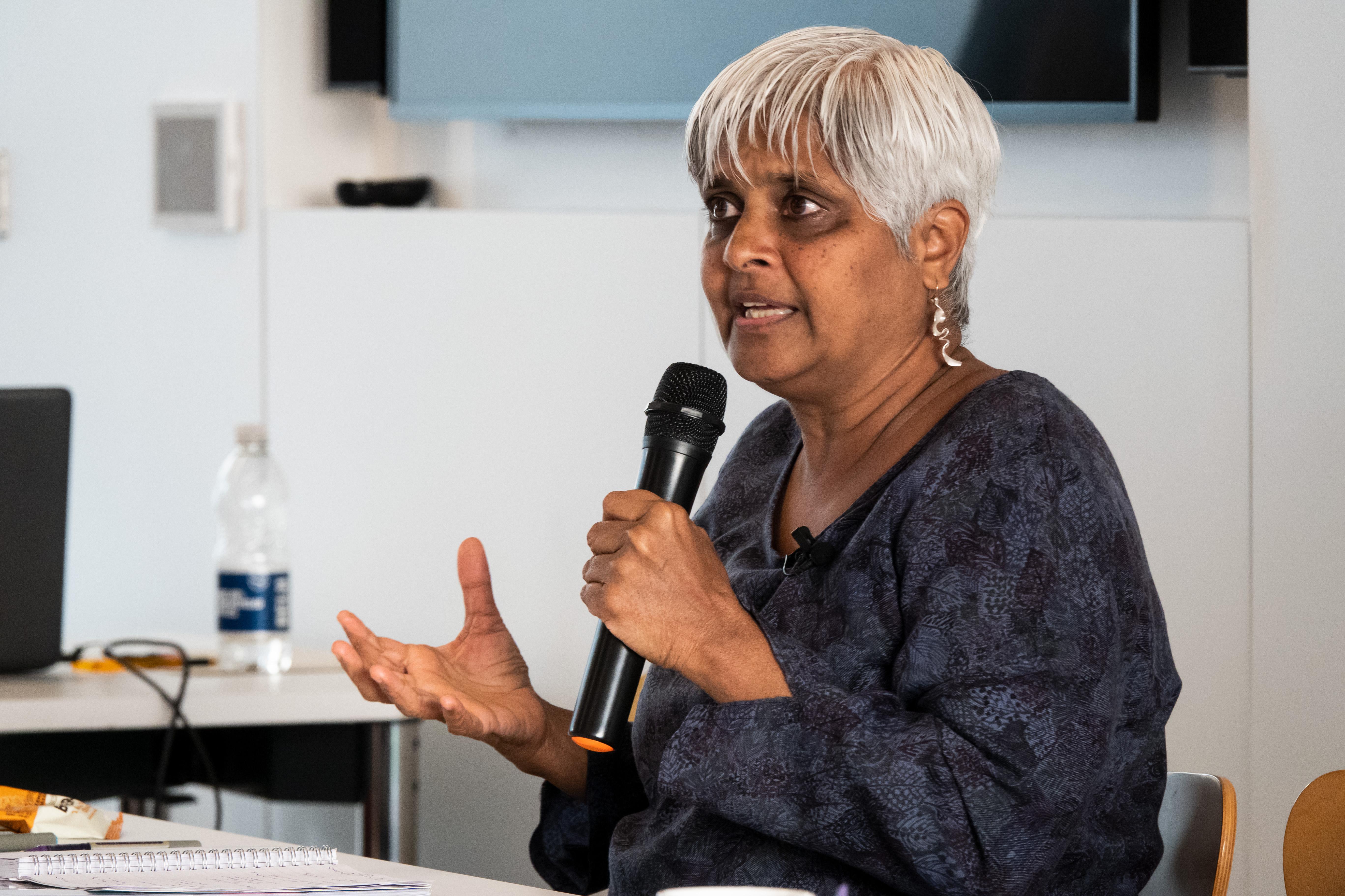 Pragna Patel  speaking into a microphone