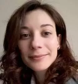 A close up photo of Pinelopi gently smiling while looking into the camera.