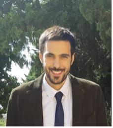 An image of Stravos smiling with trees in the background