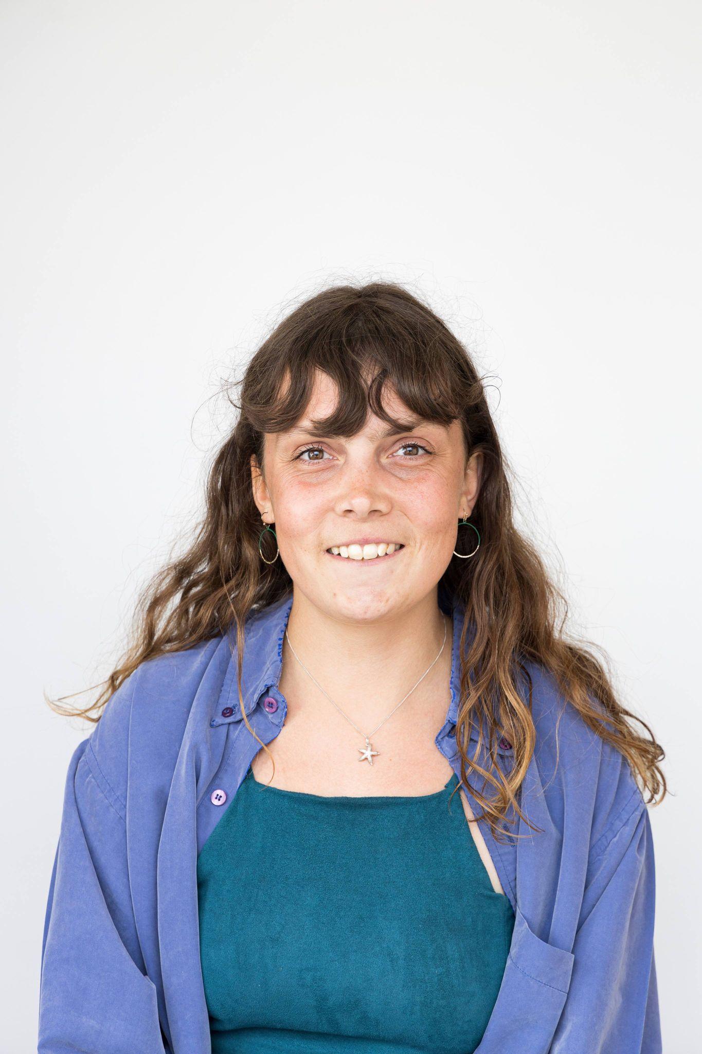 An image of Amy dressed in a blue shirt