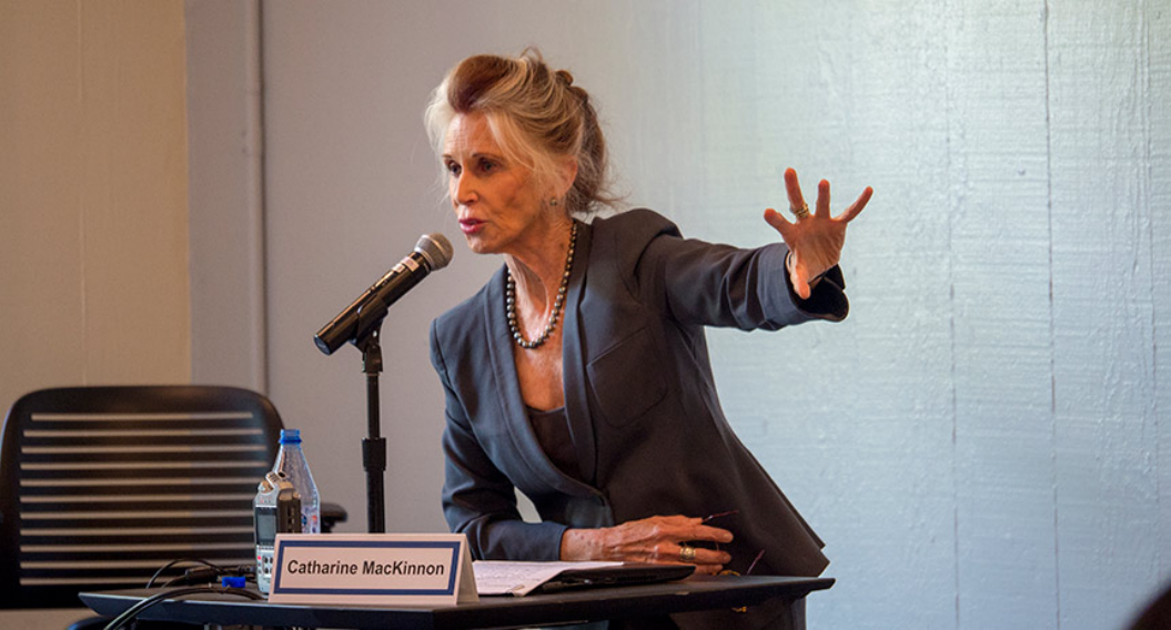 A photograph of Catharine A MacKinnon speaking at a lecturn