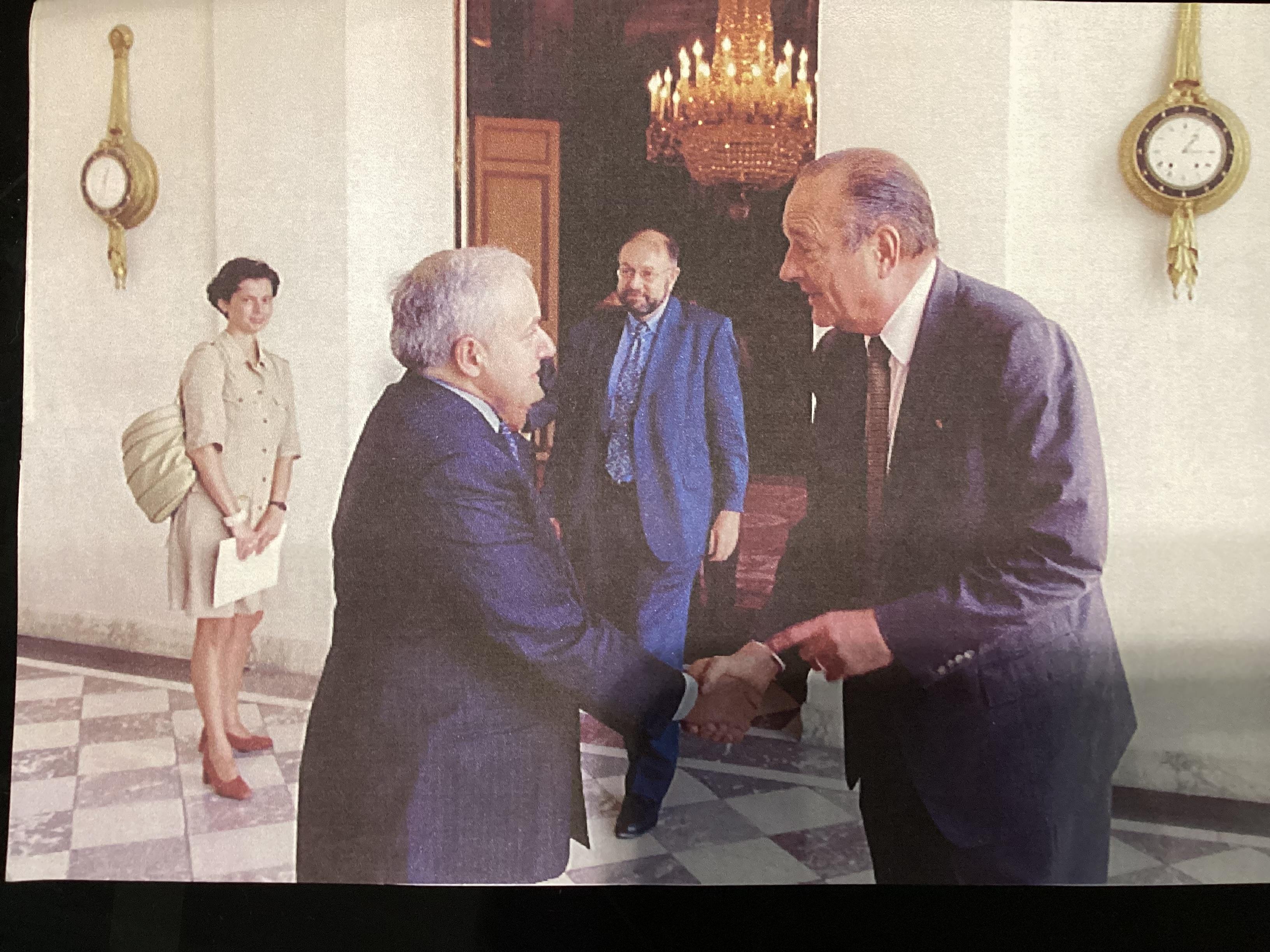 Basil Markesinis shaking hands with another man