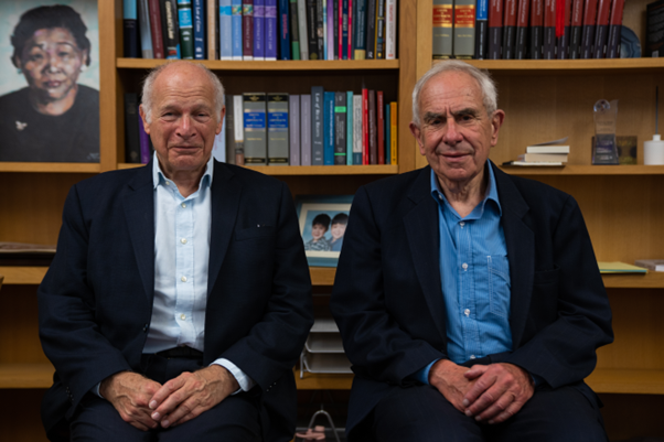 Lords Hoffman and Neuberger in front of a bookcase