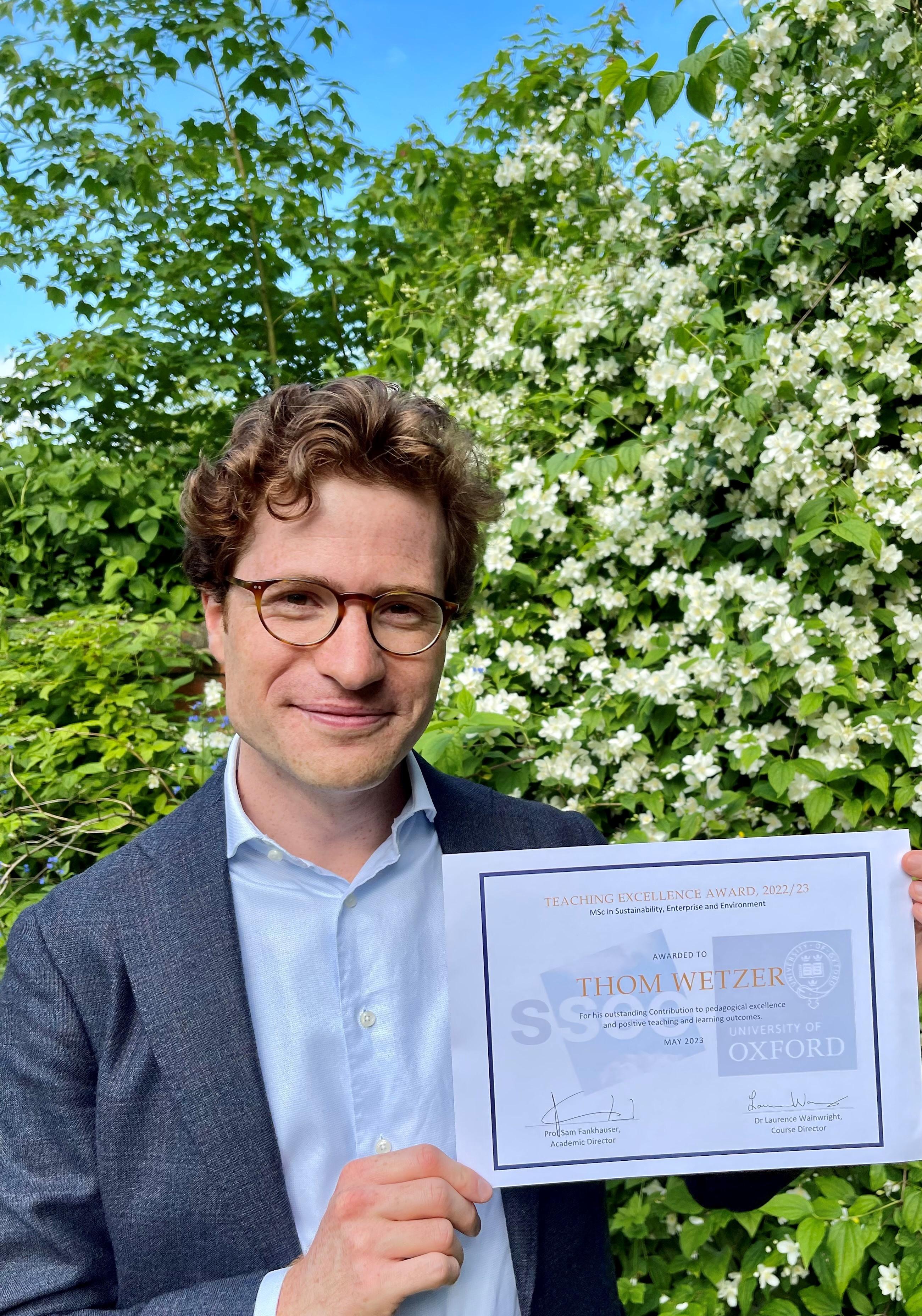 Thom Wetzer holding his Teaching Excellence Award