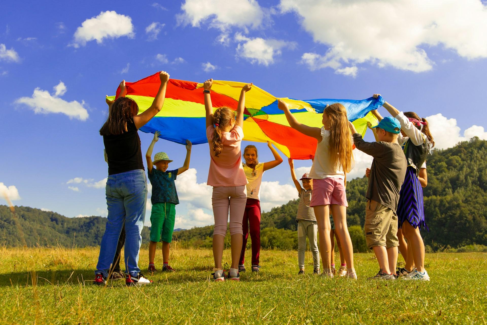 Group of children standing on green field during breaktime