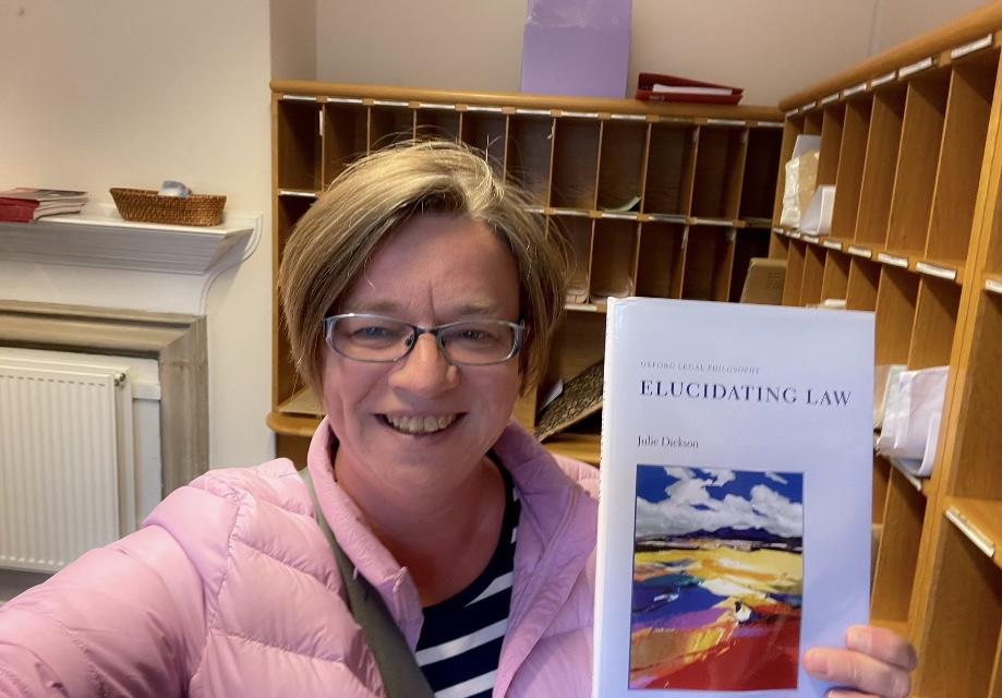 Julie Dickson holding her book - Elucidating Law