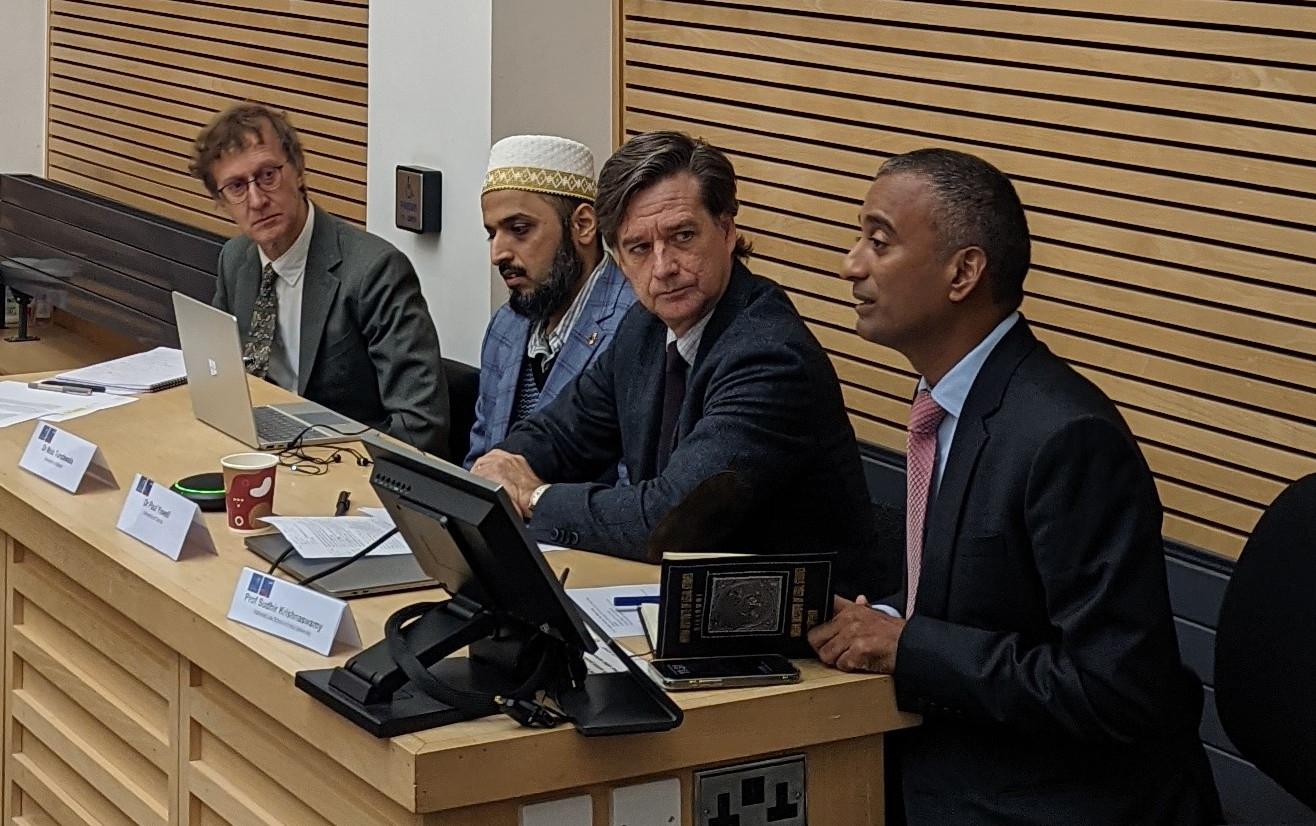 4 panel members at a conference 