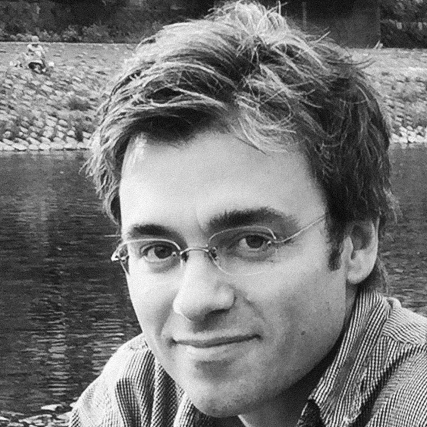 Black and white photograph of Christian Lammerts (man, clean shaven, short wavy hair, wearing glasses), of Rutgers University