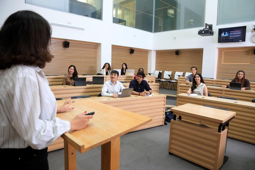 Students listening to a lecture in The Cube facility within the St Cross Building
