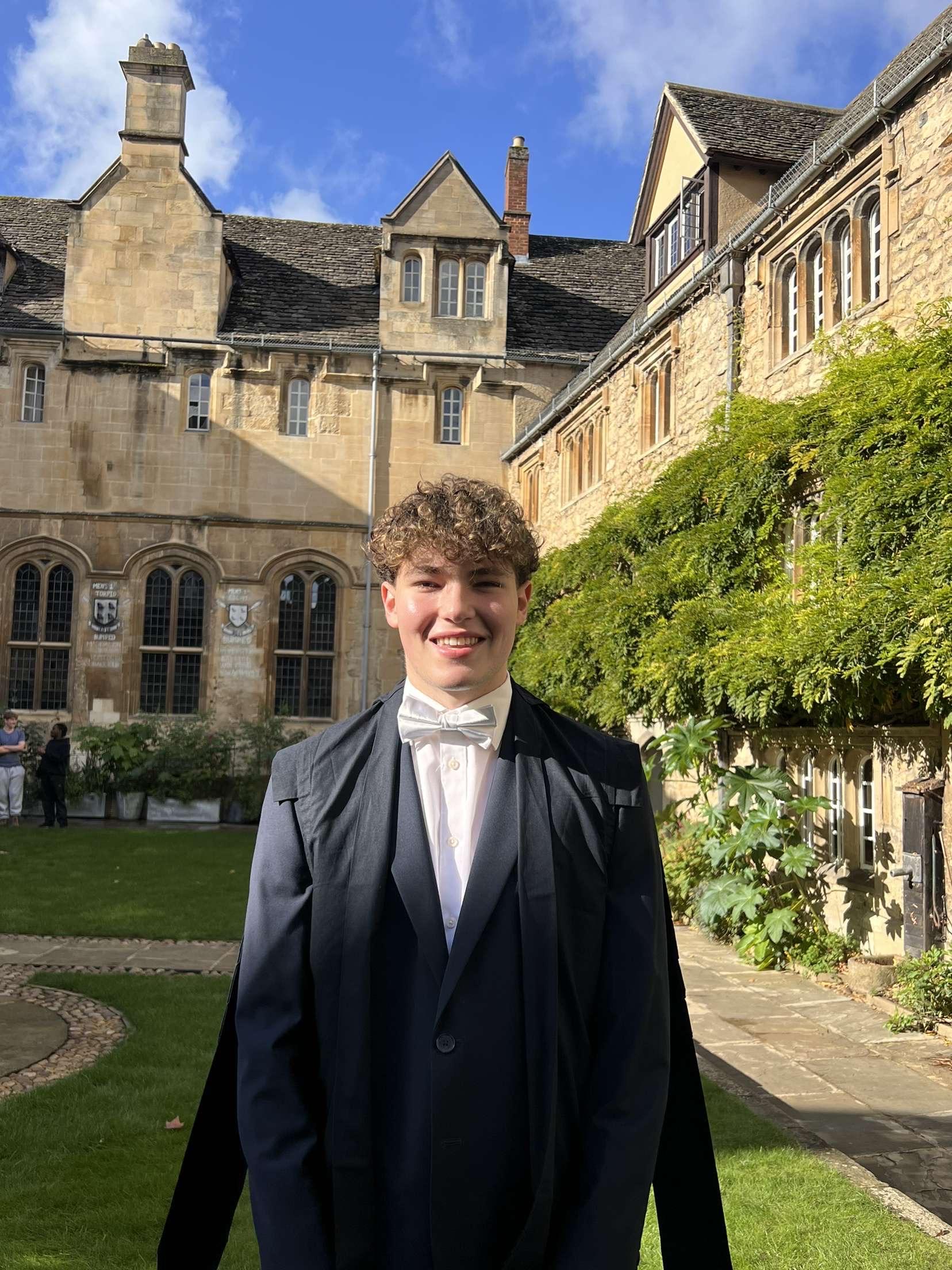 boy with brown hair in sub fusc in the sun