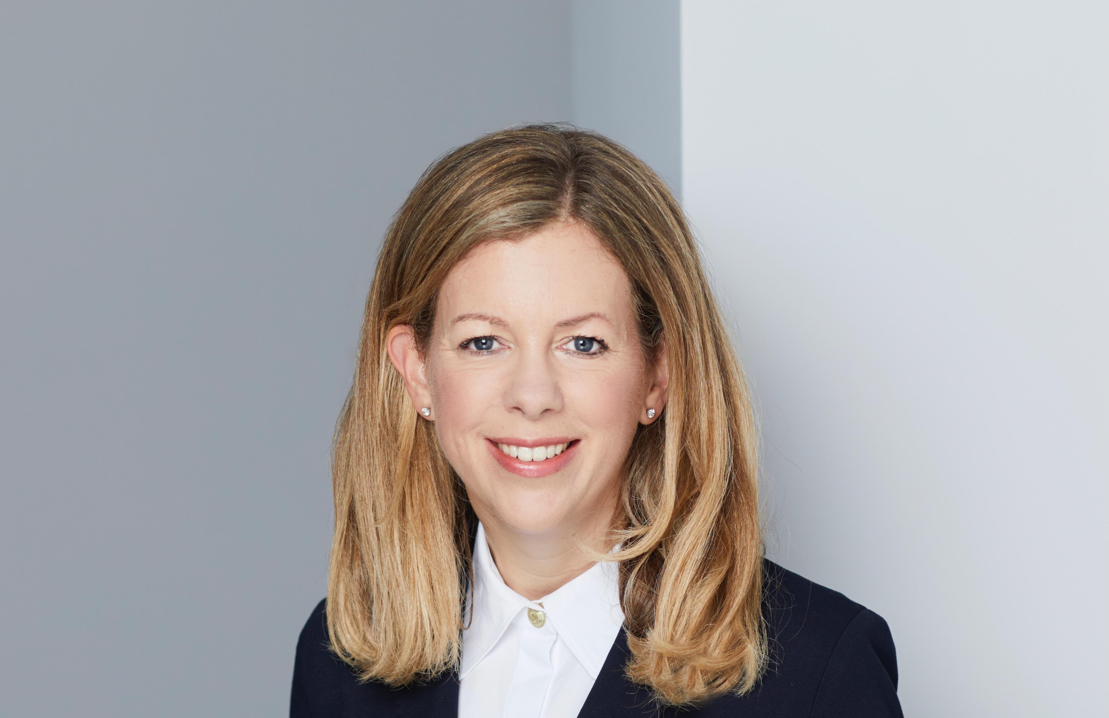 Headshot of Claire Darwin KC in a white formal short and black blazer