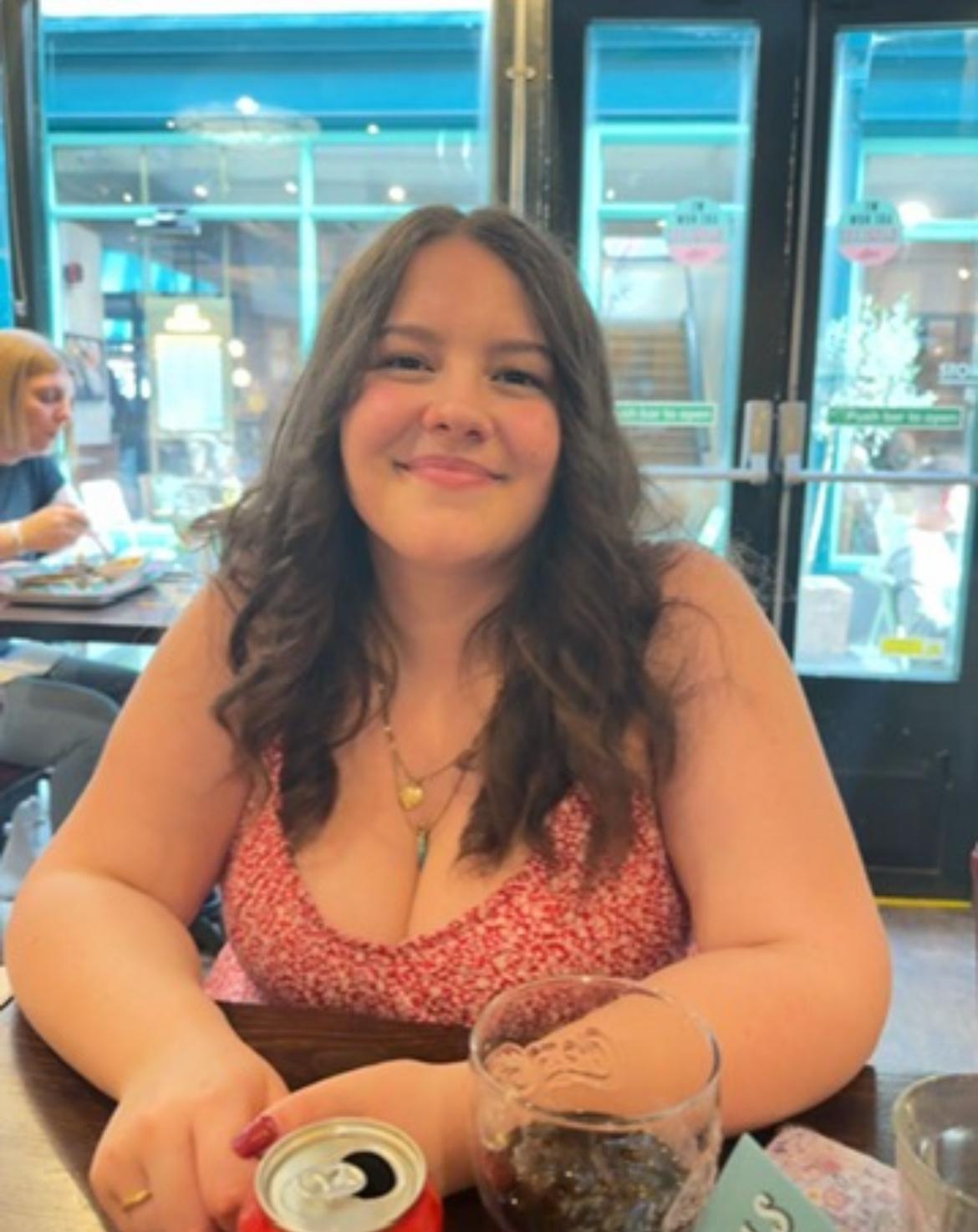 girl with brown hair in a pink top
