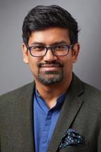 Rohit De in a charcoal blazer and blue formal shirt