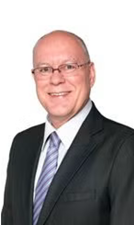 Andrew Harding in blazer, formal shirt, and tie