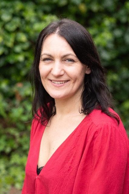 Photo of Sophie Bray-Watkins in a red blouse.