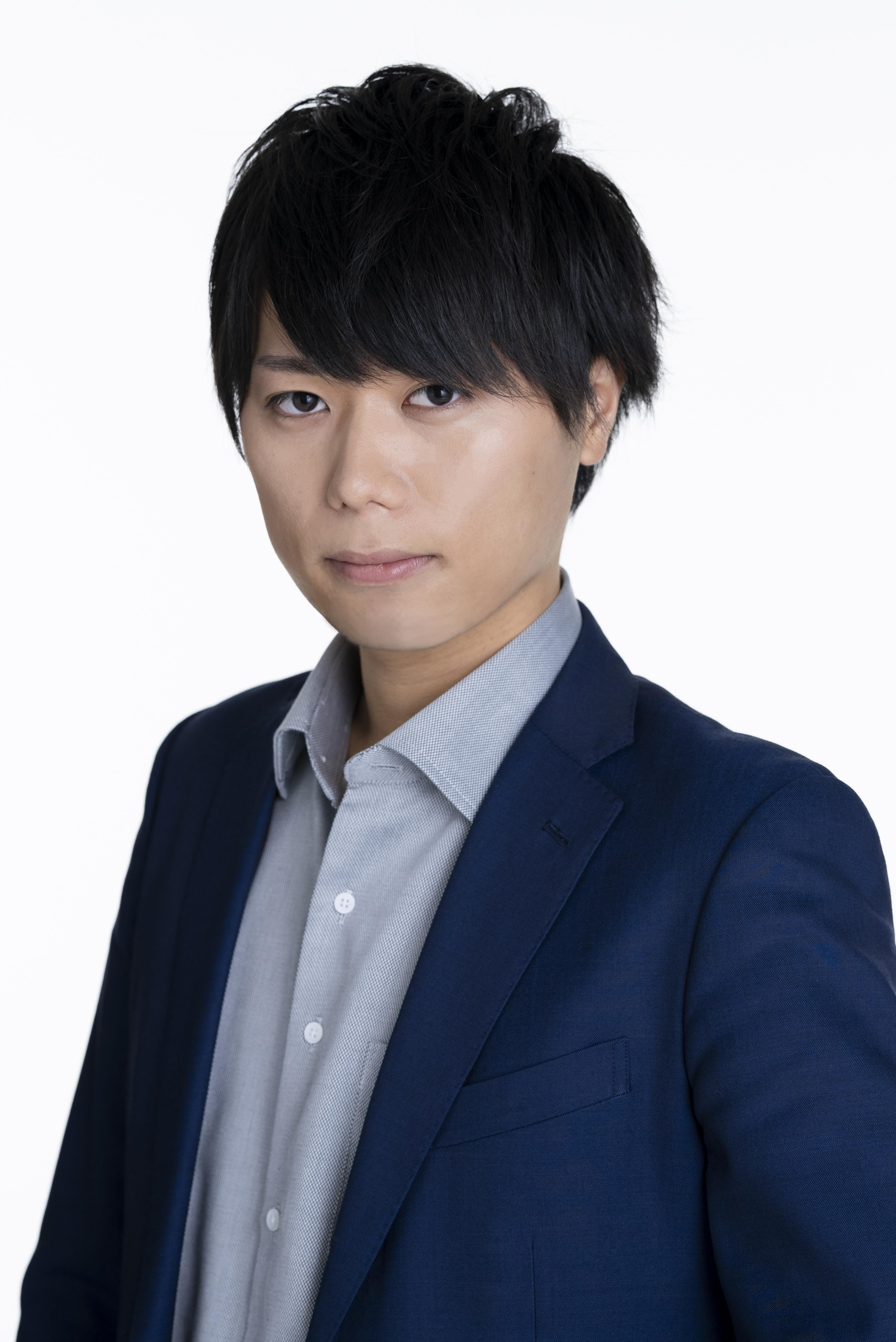 Photo of Dr Yosuke Nagai. He is wearing a dark blue blazer with a light blue button-up shirt with an open collar.