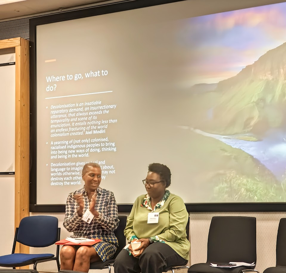 Image of Professor Iyiola Solanke in conversation with Professor Foluke Adebisi
