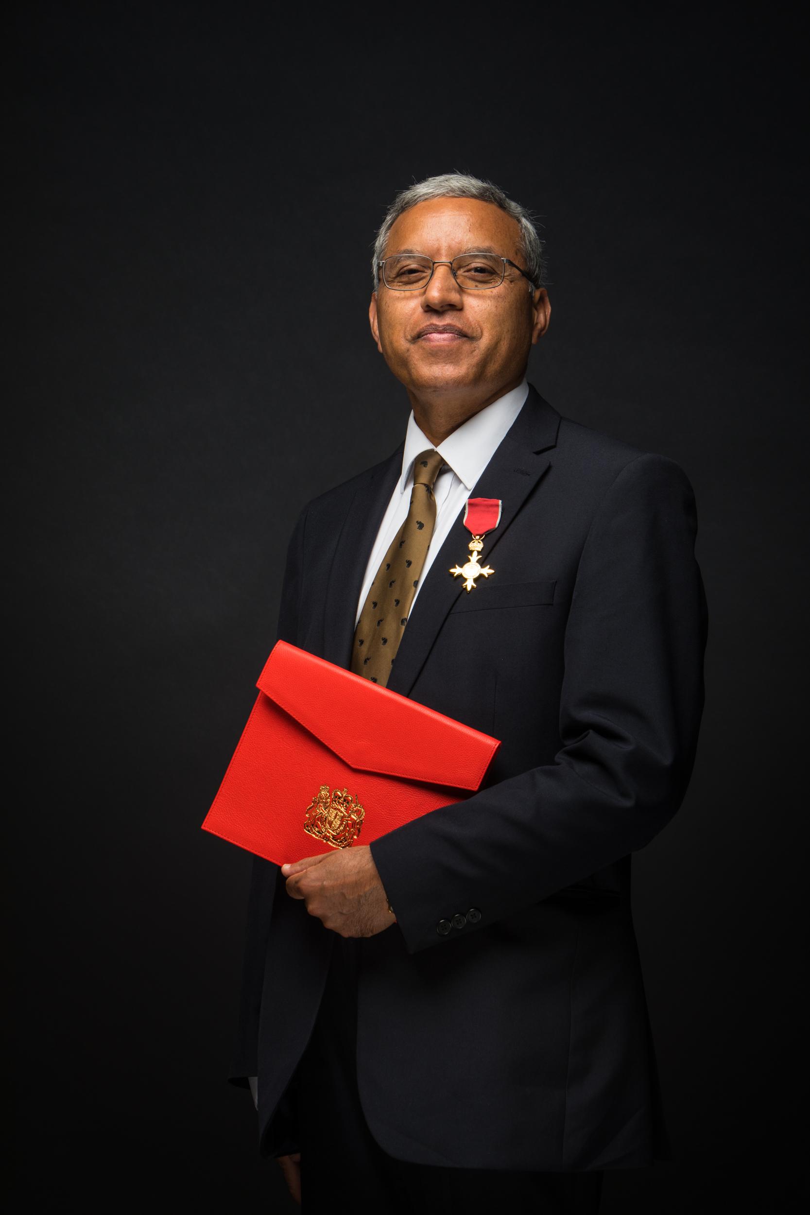 Professor Subedi holding a red book.